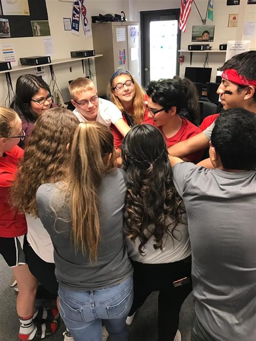 High school students with hands together 